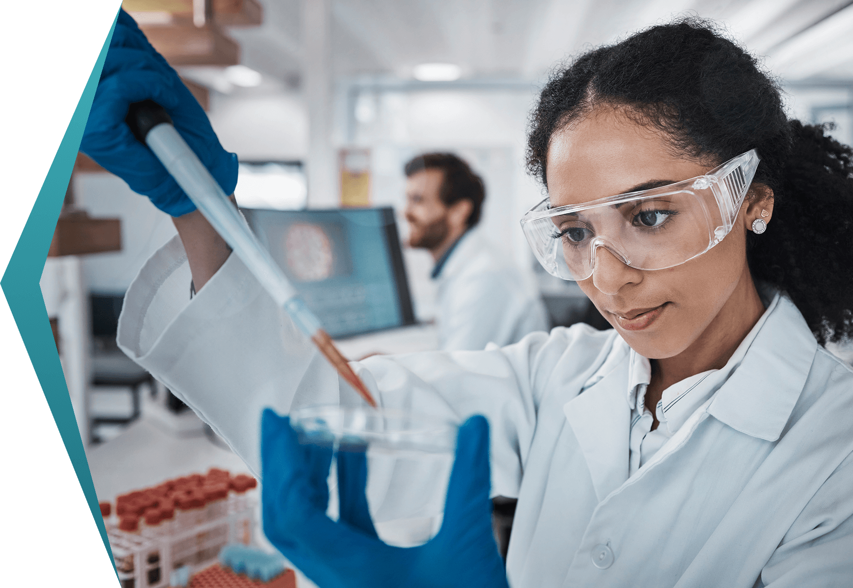 Scientist conducting experiment with pipette and petri dish.